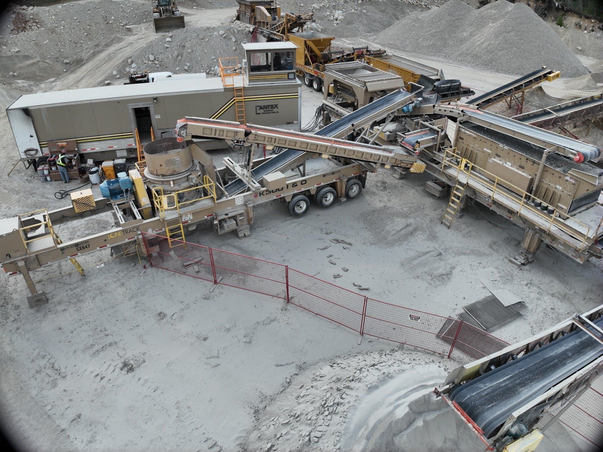 A Cantex screen deck and its stacking conveyors running from above, each belt dropping a separate size of finished product.