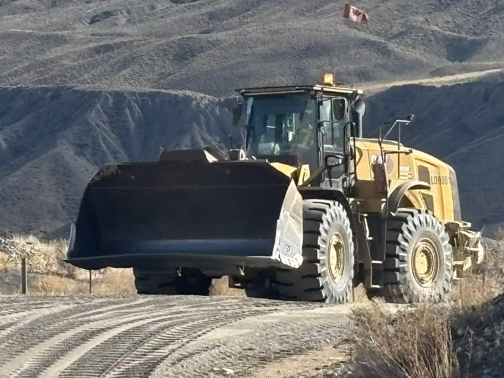 A wheel loader with a Canadian flag working in the Cantex pit.