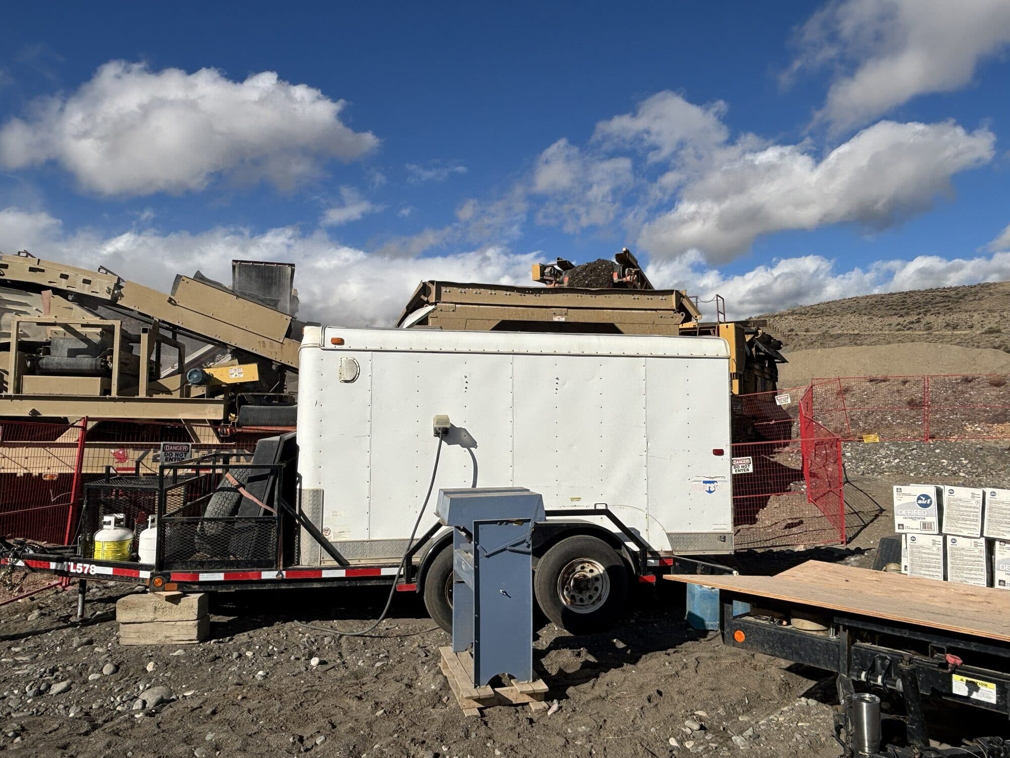 A Cantex on-site quality control testing trailer parked beside the screening plant, with an electrical splitter cabinet in front of it.