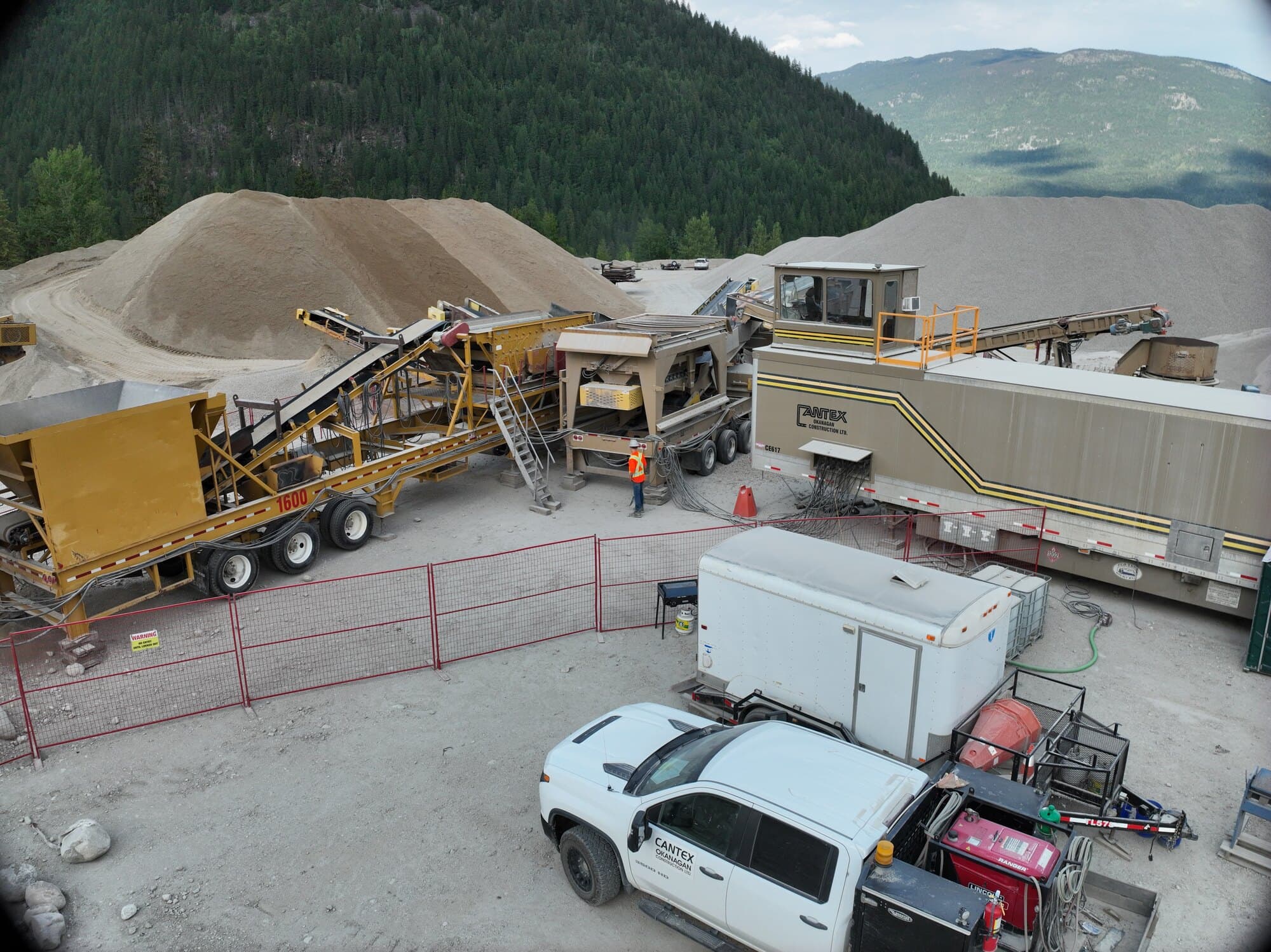 A Cantex crushing setup on site with the site office, a pickup, and the crew's support trailers parked alongside the plant.