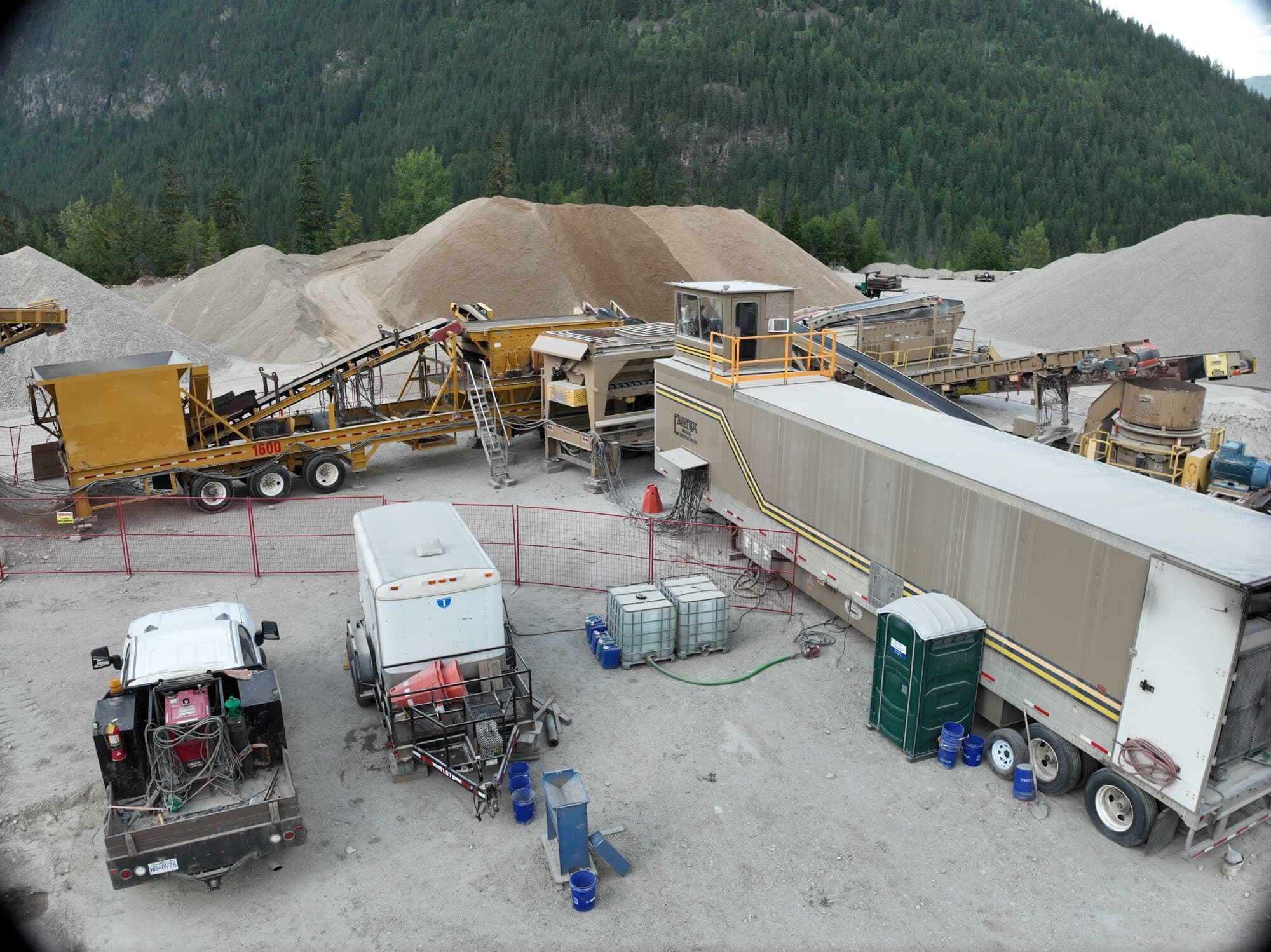The support side of a Cantex crushing setup: the site office, the crew trailers, water tanks, and fuel storage laid out behind the plant.