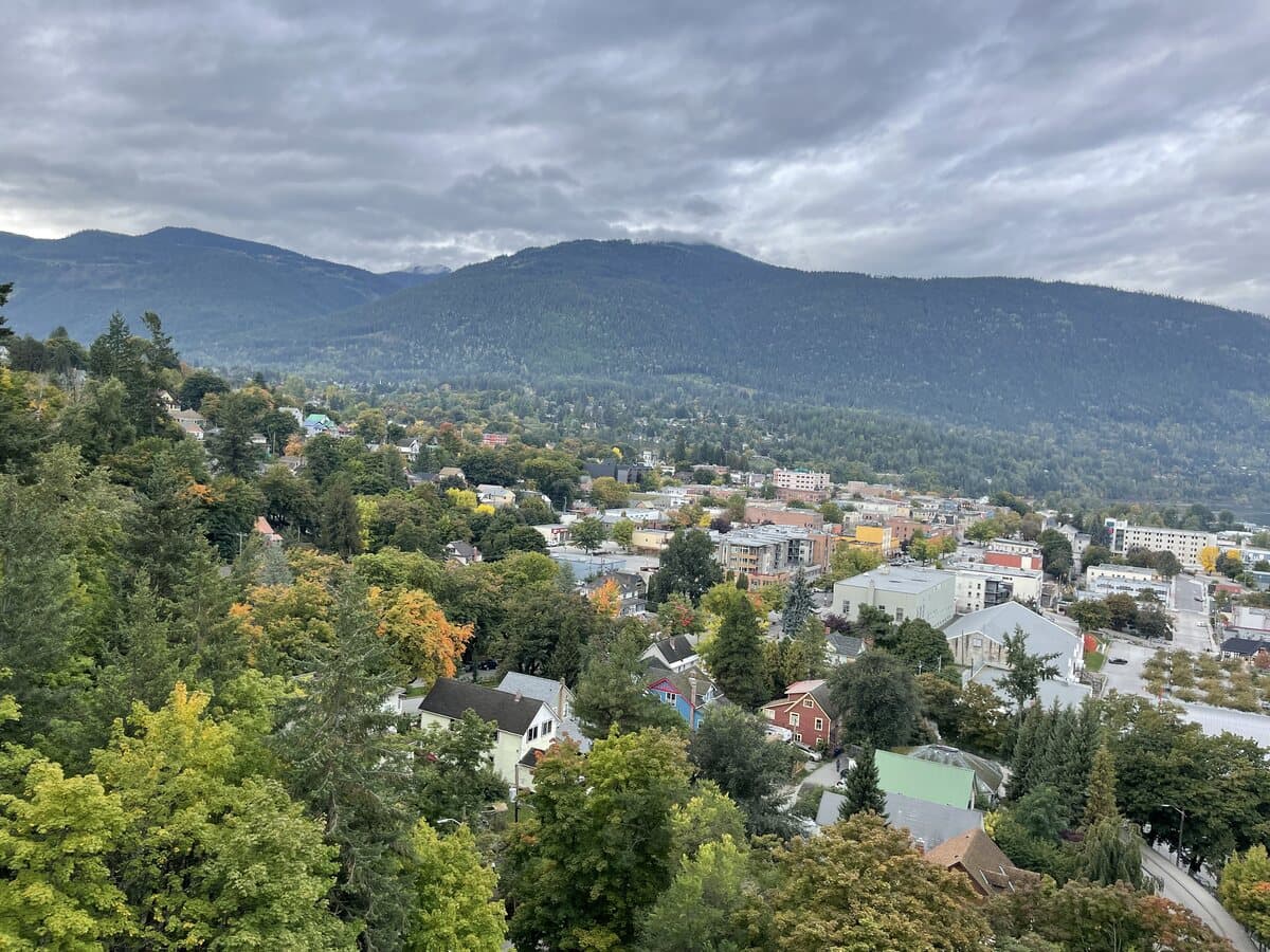 The city of Nelson seen from Gyro Park, with its heritage rooftops stepping down the hillside toward Kootenay Lake.