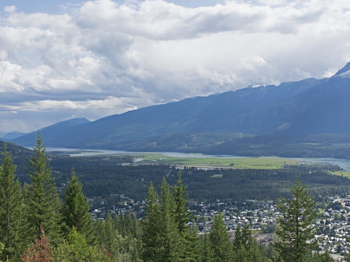 The city of Revelstoke and the Columbia River valley seen from the Meadows in the Sky Parkway, ringed by the Monashee and Selkirk mountains.