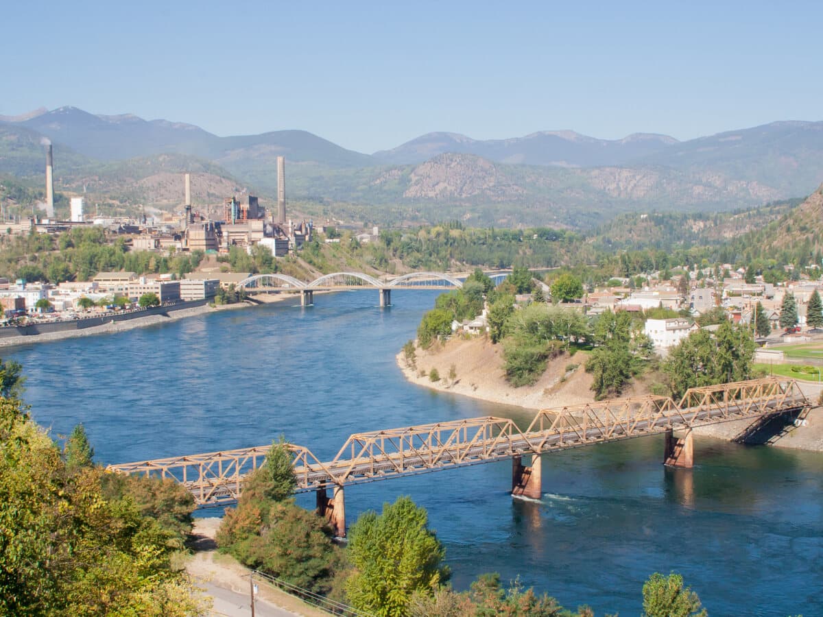 A hillside view over Trail, showing the Columbia River, the city's bridges and the surrounding Kootenay mountains.